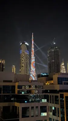 a group of tall buildings in a city at night at The Pad Burj Khalifa view 1Bd in Dubai