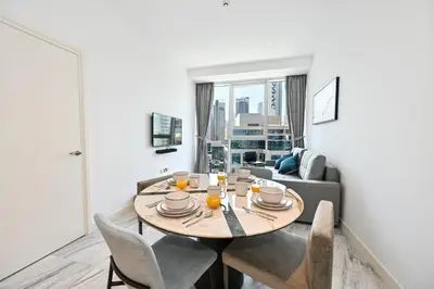 a living room with a table and a couch at The Pad Burj Khalifa view 1Bd in Dubai