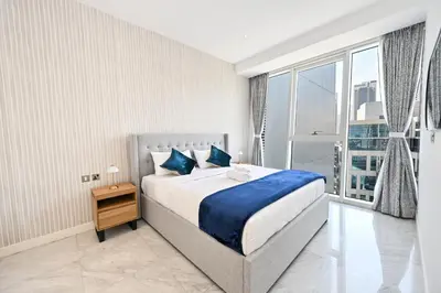a bedroom with a large bed and a large window at The Pad Burj Khalifa view 1Bd in Dubai