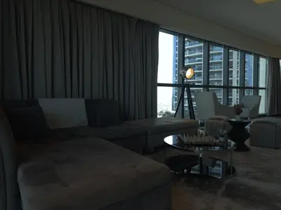 a living room with a couch and a table at HollywoodDXB Burj Khalifa View - 6Min To Dubai Mall in Dubai