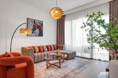 a living room with a couch and a table at Elegant 2BR by Dubai Mall in Dubai