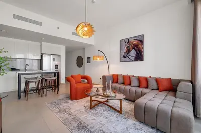 a living room with a couch and a table at Elegant 2BR by Dubai Mall in Dubai