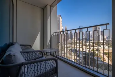 a balcony with two benches and a view of a city at Elegant 2BR by Dubai Mall in Dubai