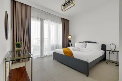 a bedroom with a bed and a large window at Elegant 2BR by Dubai Mall in Dubai