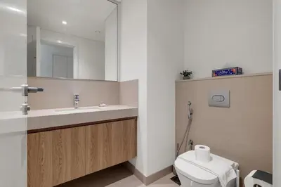a bathroom with a toilet and a sink and a mirror at Elegant 2BR by Dubai Mall in Dubai