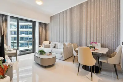 a living room with a couch and a table and chairs at Dubai Marina View - 2BR APT with Pool & Gym in Dubai