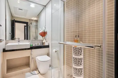 a bathroom with a toilet and a sink at Dubai Marina View - 2BR APT with Pool & Gym in Dubai