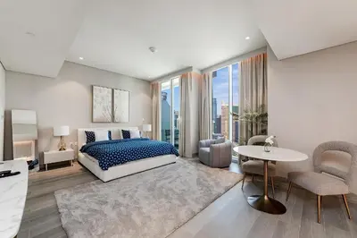 a bedroom with a bed and a table and chairs at Great Apartments at Marina Star with City View in Dubai