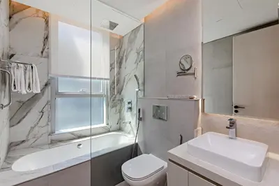 a bathroom with a sink and a toilet and a tub at Great Apartments at Marina Star with City View in Dubai