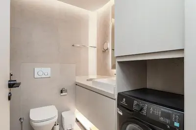 a small bathroom with a washing machine and a sink at Great Apartments at Marina Star with City View in Dubai