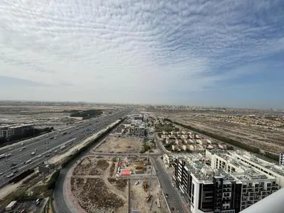 an aerial view of a city with a highway at Cozy Studio Apartment Holiday Home l Perfect for Couples in Dubai
