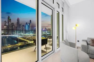 a living room with a view of a city at Sea View 2BR Near Beach Marina Walk & Dining Spots in Dubai