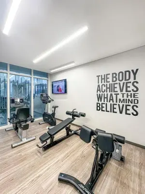 a gym with several treadmills and cardio machines at Sea View 2BR Near Beach Marina Walk & Dining Spots in Dubai