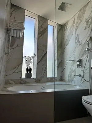 a bathroom with a tub and a window and a sink at Entire apartment in Dubai Marina in Dubai