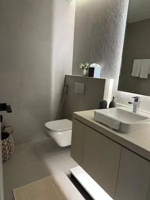 a bathroom with a sink and a toilet and a mirror at Entire apartment in Dubai Marina in Dubai