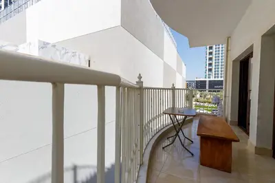 a balcony of a building with a wooden table at Cozy 1BR Apartment in Lolena Tower, JVC - Allsopp & Allsopp in Dubai