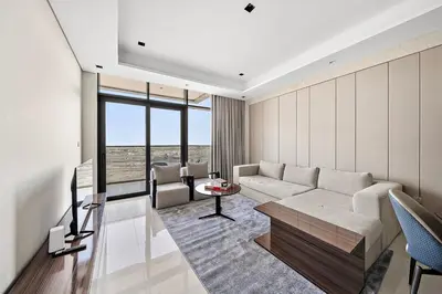 a living room with a couch and a television at FIRST CLASS 1BR Elegant Modern Retreat in Dubai