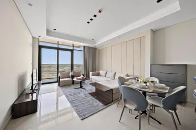 a living room with a couch and a table with chairs at FIRST CLASS 1BR Elegant Modern Retreat in Dubai