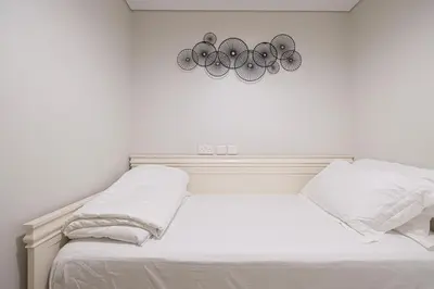 a white room with a bed and two lights at UrbanHomes - Luxury and Cozy 3BDR Apartment in Business Bay Canal View in Dubai