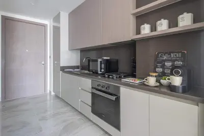 a kitchen with a stove and a microwave at Frank Porter - Peninsula Five in Dubai