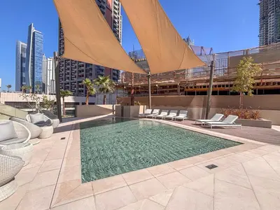 a swimming pool on the roof of a building at Frank Porter - Peninsula Five in Dubai
