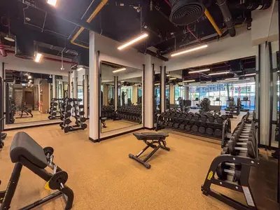 a gym with a lot of treadmills and mirrors at Frank Porter - Peninsula Five in Dubai