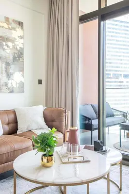 a living room with a couch and a table at Frank Porter - Peninsula Five in Dubai
