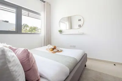 a bedroom with a bed with a teddy bear on it at Frank Porter - Avencia 44 in ‘Ūd al Bayḑāʼ