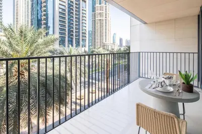 a balcony with a table and chairs and a view of the city at Frank Porter - Boulevard Heights in Dubai