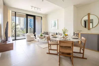 a dining room and living room with a table and chairs at Frank Porter - Boulevard Heights in Dubai