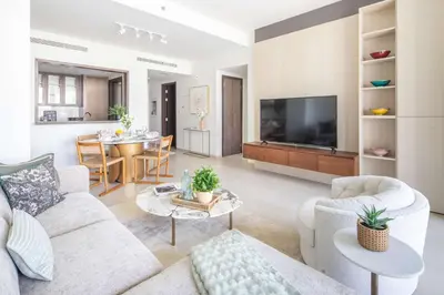 a living room with a couch and a dining room at Frank Porter - Boulevard Heights in Dubai