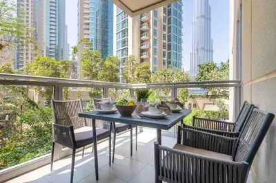 a table and chairs on a balcony with a view of the city at Frank Porter - The Residences 5 in Dubai