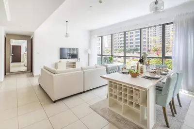 a living room with a table and a couch at Frank Porter - The Residences 5 in Dubai