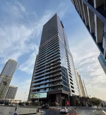 a tall building in the middle of a city at High-Rise 1BR with Lake and City Views and Minutes to Metro, MBL Royal, Jumeirah Lake Towers by Deluxe Holiday Homes in Dubai