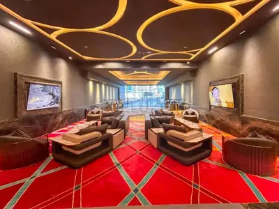 a large room with couches and a red carpet at High-Rise 1BR with Lake and City Views and Minutes to Metro, MBL Royal, Jumeirah Lake Towers by Deluxe Holiday Homes in Dubai
