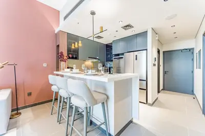 a kitchen with a large island with bar stools at High-Rise 1BR with Lake and City Views and Minutes to Metro, MBL Royal, Jumeirah Lake Towers by Deluxe Holiday Homes in Dubai