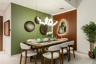 a dining room with a long table and chairs at Luxury Apartment with Burj Khalifa Views - 5-Min Walk to Dubai Mall - Newly Upgraded - 10 people - Near Dubai Opera in Dubai