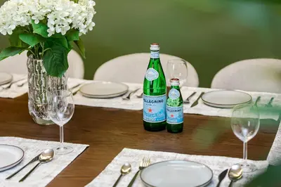 a wooden table with two bottles of wine on it at Luxury Apartment with Burj Khalifa Views - 5-Min Walk to Dubai Mall - Newly Upgraded - 10 people - Near Dubai Opera in Dubai