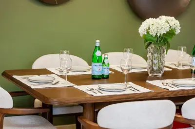 a wooden table with glasses and bottles of wine at Luxury Apartment with Burj Khalifa Views - 5-Min Walk to Dubai Mall - Newly Upgraded - 10 people - Near Dubai Opera in Dubai