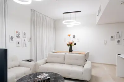 a living room with a couch and a table at Veluxa - Renovated 1BHK next to Golf in Dubai