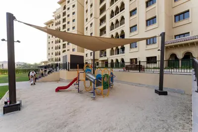 a playground with a hammock in front of a building at Veluxa - Renovated 1BHK next to Golf in Dubai