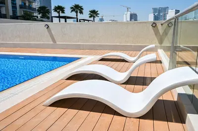 a swimming pool on the roof of a building at Stylish 1BR Apartment - Central Location in JVC - Balcony - Holiday Boulevard in Dubai