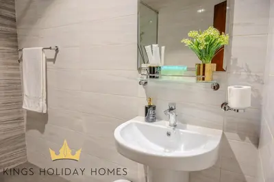 a bathroom with a sink and a mirror at Dunya Tower Royal suites in Dubai