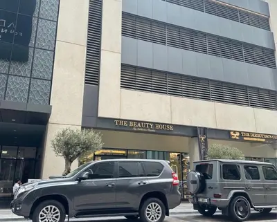 a gray suv parked in front of a building at Dunya Tower Royal suites in Dubai
