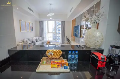 a living room with a table with food on it at Dunya Tower Royal suites in Dubai