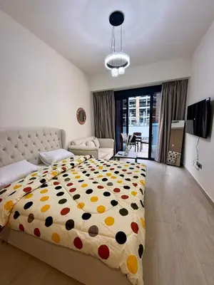 a bedroom with a large bed with a polka dot blanket at Azizi Riviera 43 in Dubai
