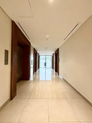 an empty hallway of an office building with a glass door at Azizi Riviera 43 in Dubai
