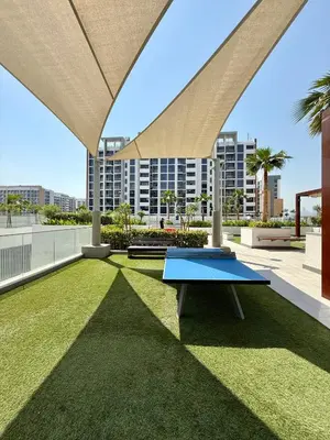 a ping pong table on the roof of a building at Azizi Riviera 43 in Dubai