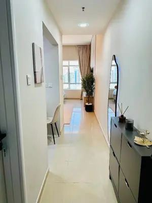 a hallway with a dresser and a mirror in a room at Lake City Tower in Dubai