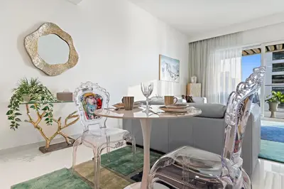 a dining room with a table and two chairs at Fendi 1BR with Panoramic Sea View in Dubai